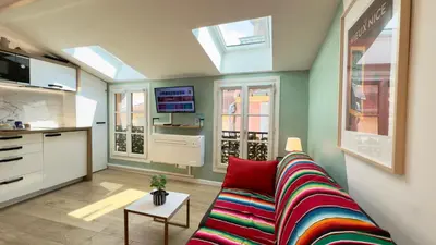 a living room with a couch and a kitchen at Ze Perfect Place - Magnifique Studio Vieux Nice in Nice