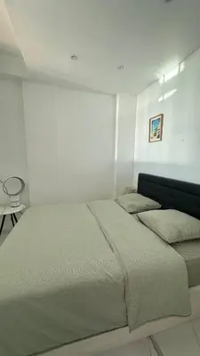 a bedroom with a large bed in a white room at Carre d Or Face a la Mer in Nice