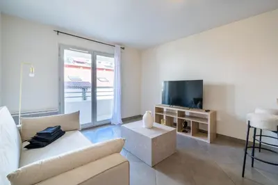 a living room with a couch and a tv at Cozy 2P Port de Nice garage in Nice