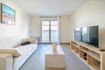 a living room with a couch and a flat screen tv at Cozy 2P Port de Nice garage in Nice