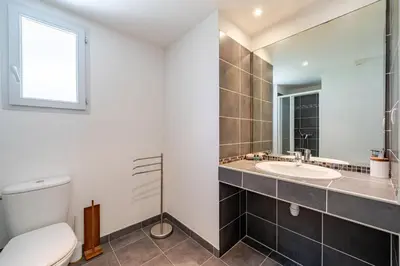a bathroom with a toilet and a sink at Cozy 2P Port de Nice garage in Nice