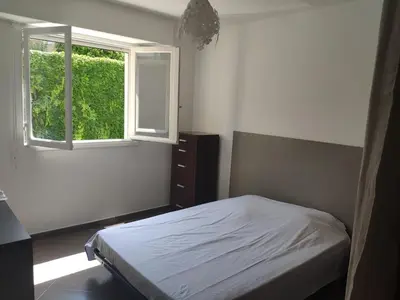 a bedroom with a bed and a window at 3 pièces 67m2 centre ville très lumineux et calme in Nice