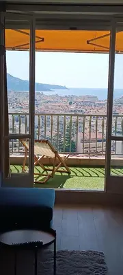 a room with a view of a city from a window at Nice, vue mer et panoramique in Nice