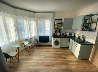 a kitchen with a table and a table and a kitchen with a stove at Nice centre studio rénové avec emplacement central in Nice