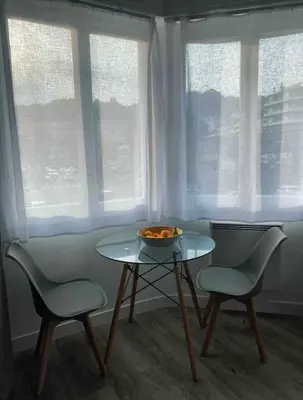 a table with two chairs and a bowl of food on it at Nice centre studio rénové avec emplacement central in Nice