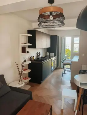 a living room with a couch and a kitchen at Nice vieille ville appartement design, proche de tout in Nice