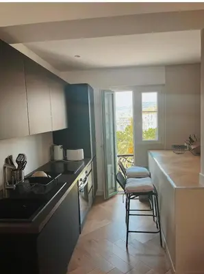 a kitchen with a counter and a chair in it at Nice vieille ville appartement design, proche de tout in Nice