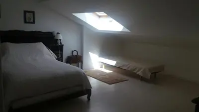a bedroom with a bed and a skylight at Beautiful Villa with large pool and garden 20 mn from Nice in Colomars
