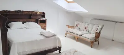 a bedroom with a bed and a couch and a chair at Beautiful Villa with large pool and garden 20 mn from Nice in Colomars