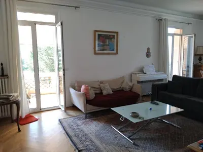 a living room with a couch and a table at Beautiful Villa with large pool and garden 20 mn from Nice in Colomars