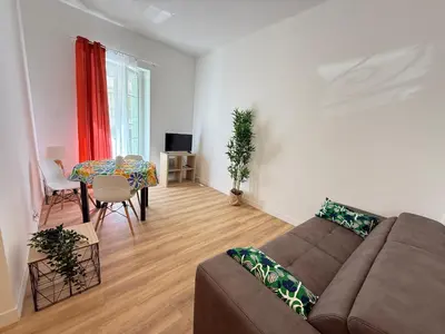 a living room with a couch and a table at Villa Amira Angely Vauban in Nice