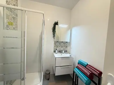 a white bathroom with a sink and a shower at Villa Amira Angely Vauban in Nice