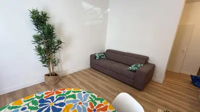 a living room with a couch and a table at Villa Amira Angely Vauban in Nice
