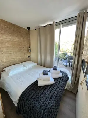 a bedroom with a bed with towels on it at Casa Monaco - Costa plana résidence in Cap d'Ail
