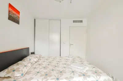 a bedroom with a bed and two white wardrobes at Charming stay in Nice in Nice