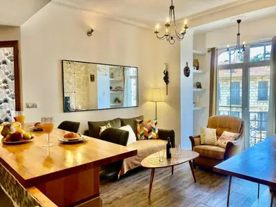 a living room with a table and a couch at Le Splendide in Nice