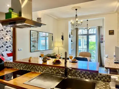a kitchen with a sink and a living room at Le Splendide in Nice