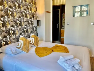 a bedroom with a white bed with towels on it at Le Splendide in Nice