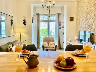 a table with plates of food and glasses of orange juice at Le Splendide in Nice