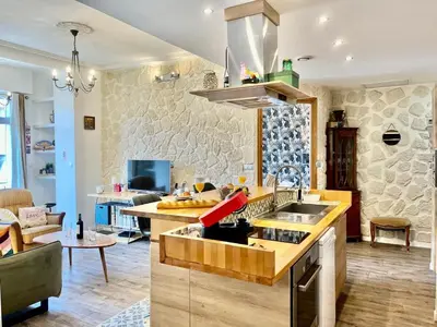 a kitchen with a sink and a living room at Le Splendide in Nice