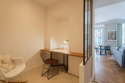 a home office with a desk and chairs in a living room at Charme et confort - centre ville de Nice in Nice