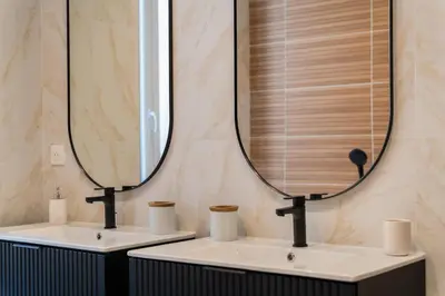 a bathroom with two sinks and a large mirror at Charme et confort - centre ville de Nice in Nice