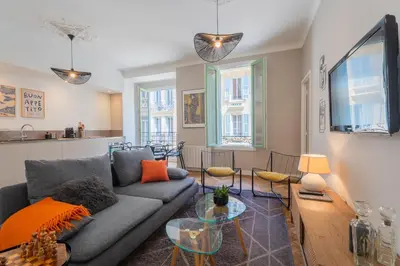 a living room with a couch and a table at Charme et confort - centre ville de Nice in Nice