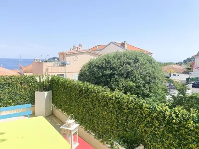 a view from the balcony of a house with a hedge at Appartamento vista mare in Saint-Jean-Cap-Ferrat