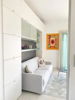 a white living room with a white couch at Appartamento vista mare in Saint-Jean-Cap-Ferrat