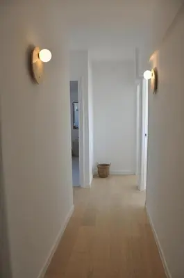 an empty hallway with white walls and wood floors at Luxury Villa Pool & Sea View in Nice