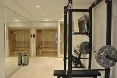 a room with a gym with a mirror at Luxury Villa Pool & Sea View in Nice