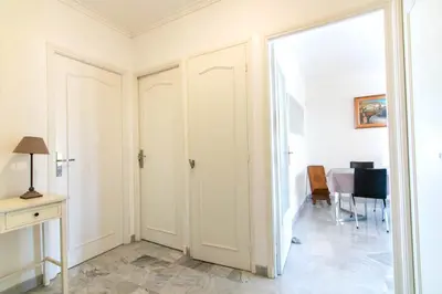 a room with two closets and a desk and a table at 3 rooms panoramic sea view in Beaulieu-sur-Mer