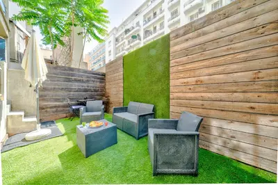 a patio with chairs and a table on grass at Studio proche mer avec jardin in Nice