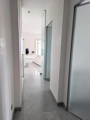 a hallway with two doors and a mirror at Suggestivo appartamento in Saint-Jean-Cap-Ferrat
