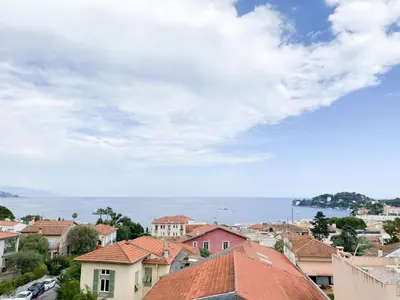 a view of a town with houses and the ocean at Suggestivo appartamento in Saint-Jean-Cap-Ferrat
