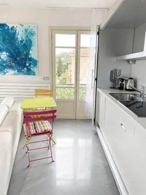 a kitchen with a couch and a table and a sink at Suggestivo appartamento in Saint-Jean-Cap-Ferrat
