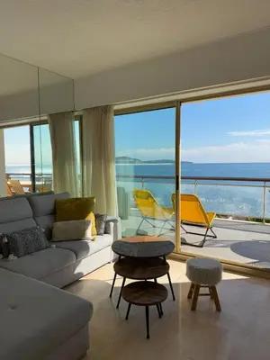 a living room with a couch and a view of the ocean at NICE, Exceptional Sea View, Top Floor, Parking in Nice