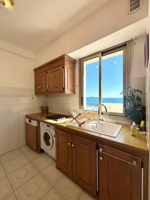 a kitchen with a sink and a washing machine at NICE, Exceptional Sea View, Top Floor, Parking in Nice