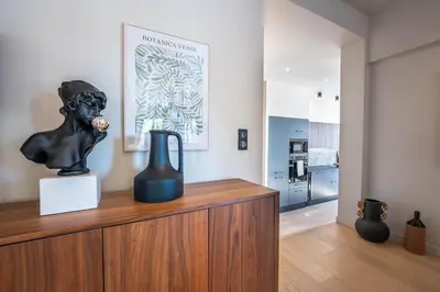 a sculpture on top of a wooden cabinet in a room at Sublime villa d'architecte, piscine et parking in Nice