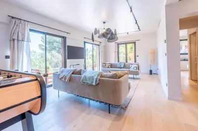 a living room with a couch and a table at Sublime villa d'architecte, piscine et parking in Nice