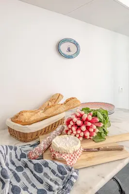 a table topped with bread and a basket of bread at La Casa Azzura in Nice