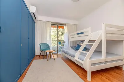 a bedroom with bunk beds with a ladder at La Casa Azzura in Nice