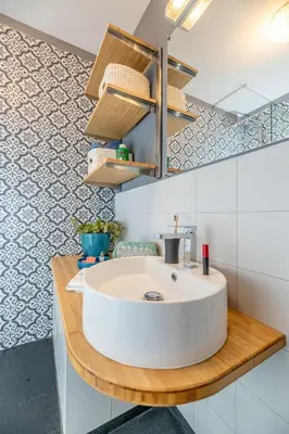 a bathroom with a white sink on a wooden counter at La Casa Azzura in Nice