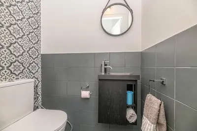 a bathroom with a toilet and a sink and a mirror at La Casa Azzura in Nice