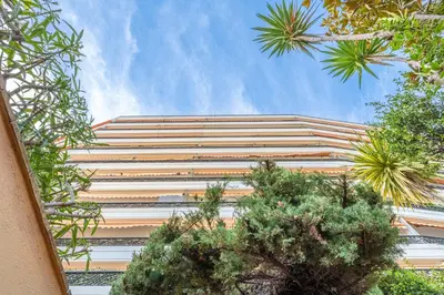 a tall building with trees in front of it at La Casa Azzura in Nice
