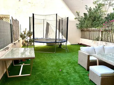 a patio with green grass and a trampoline at Wonderful apartment and garden heart of Nice in Nice