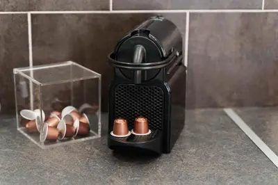 a black coffee maker sitting on a counter next to a box at Nice Renting - 5b PENCHIENATTI - Charming Cozy Studio Balcony AC Massena in Nice