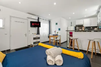 a room with a bed with towels on it at Nice Renting - 5b PENCHIENATTI - Charming Cozy Studio Balcony AC Massena in Nice