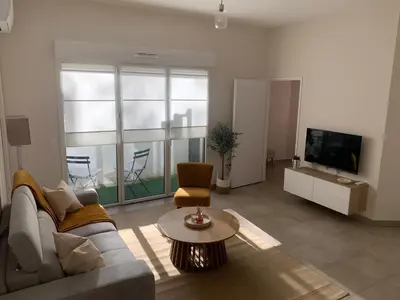 a living room with a couch and a tv at Nice virgil Barel in Nice