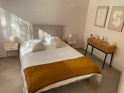 a bedroom with a large bed and a desk at Nice virgil Barel in Nice